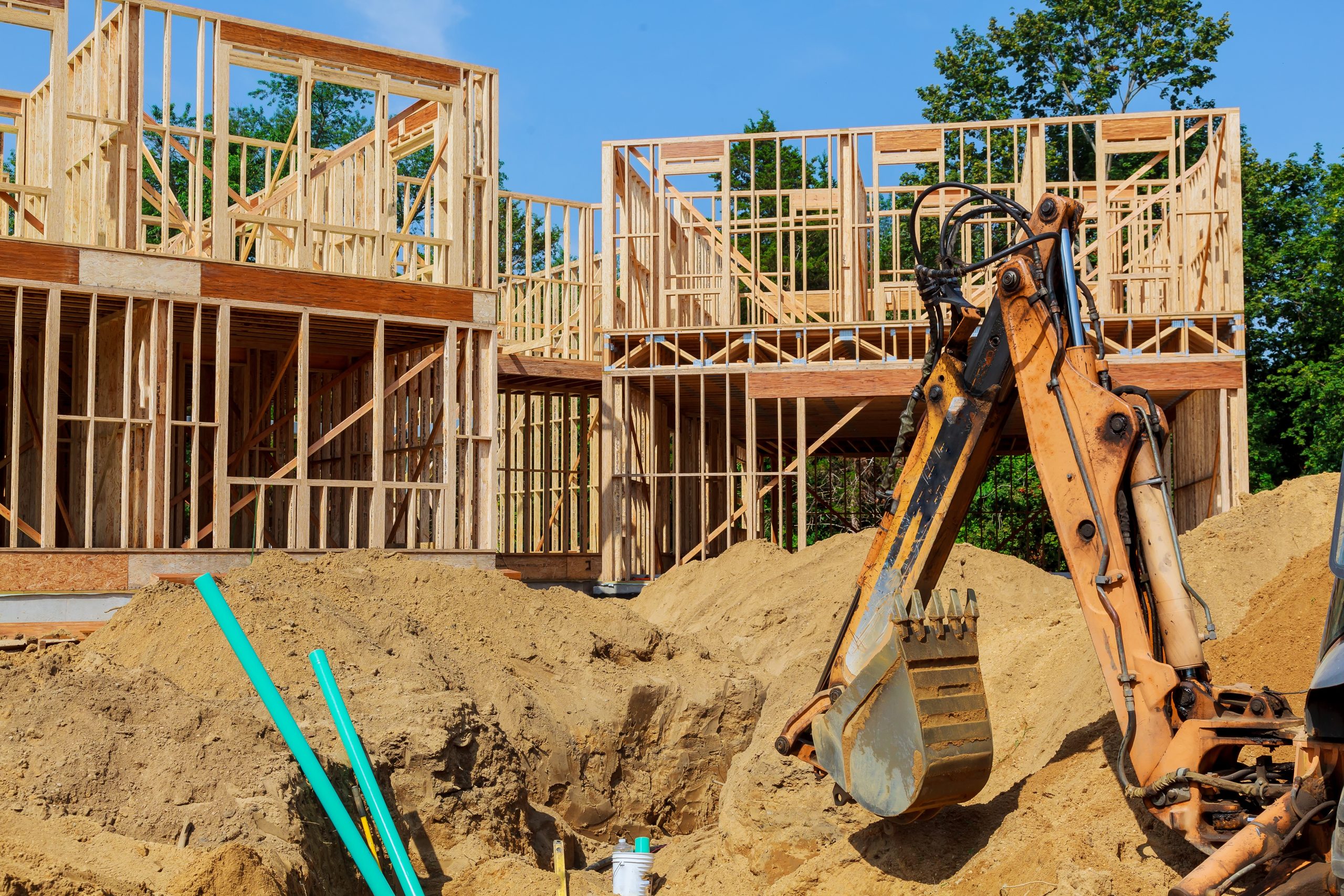 Unfinished house of still under construction. Building concept The excavator digs new building